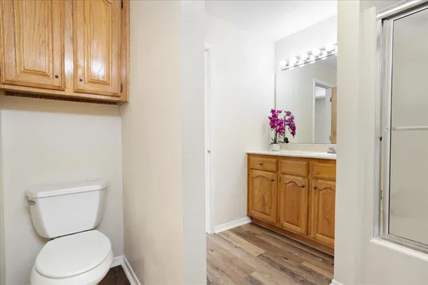 a bathroom with a toilet sink and cabinets