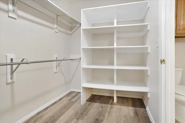 a view of walk in closet with empty racks