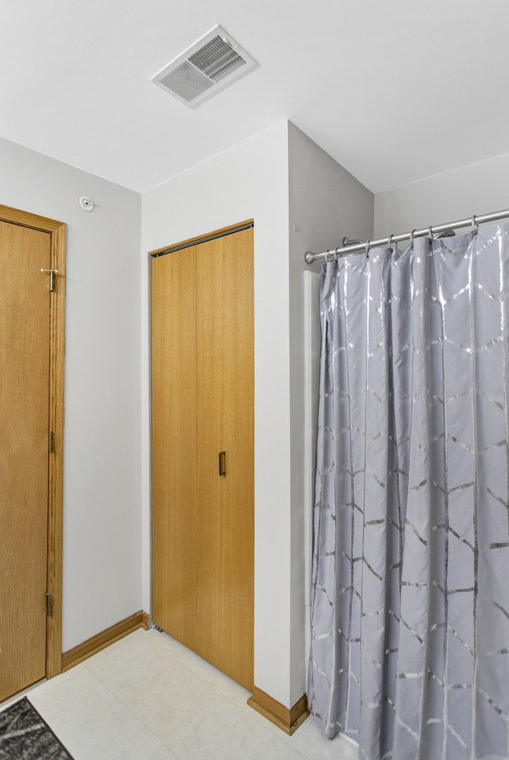 2262 Rockefeller Drive Geneva, IL 60134 - Photo 20 of 25 a view of a bathroom with a shower curtain