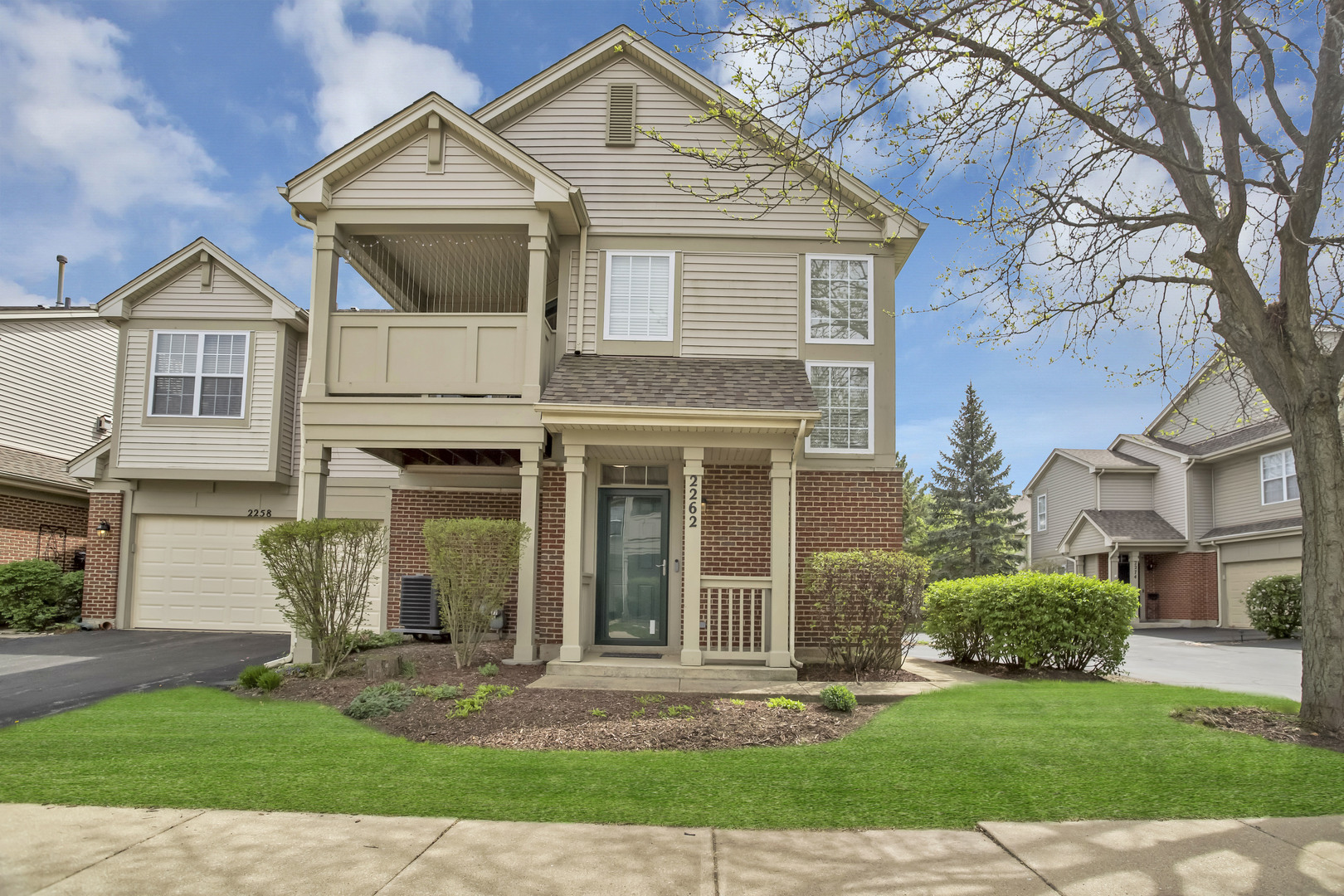 2262 Rockefeller Drive Geneva, IL 60134 - Photo 2 of 25 a front view of a house with a yard and garage