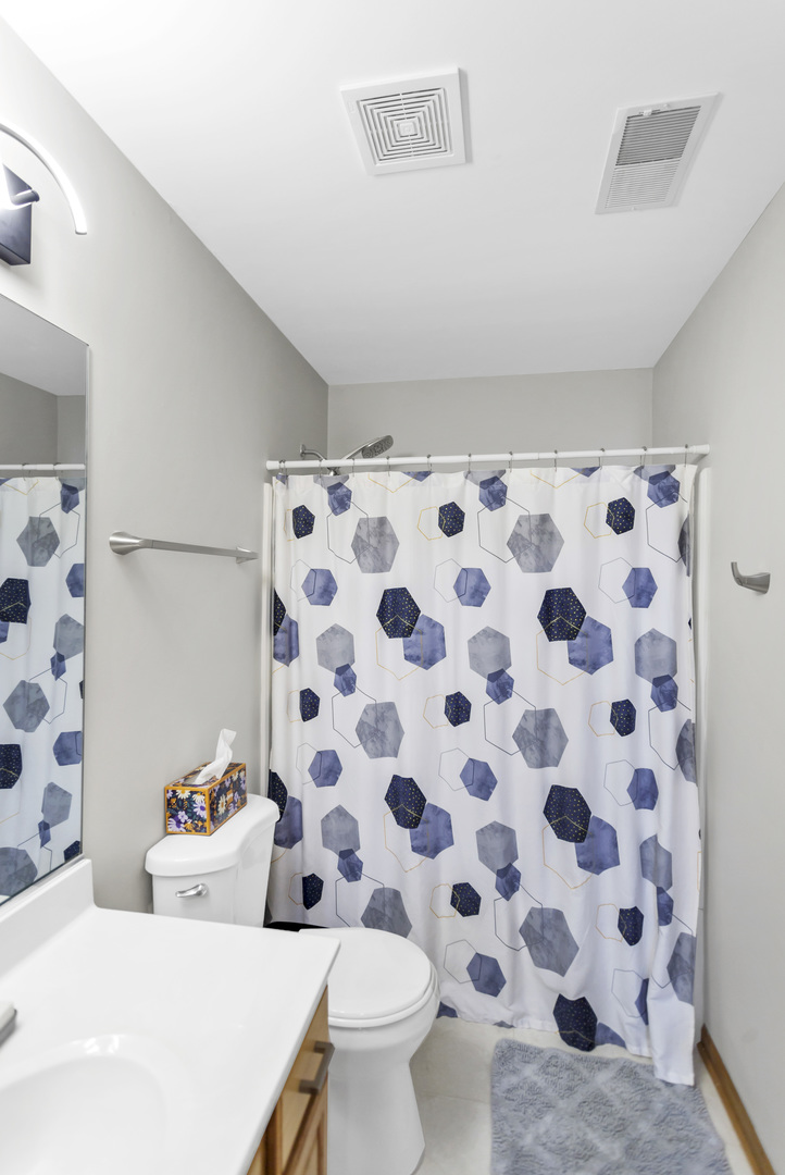 2262 Rockefeller Drive Geneva, IL 60134 - Photo 24 of 25 a white toilet sitting next to a shower curtain