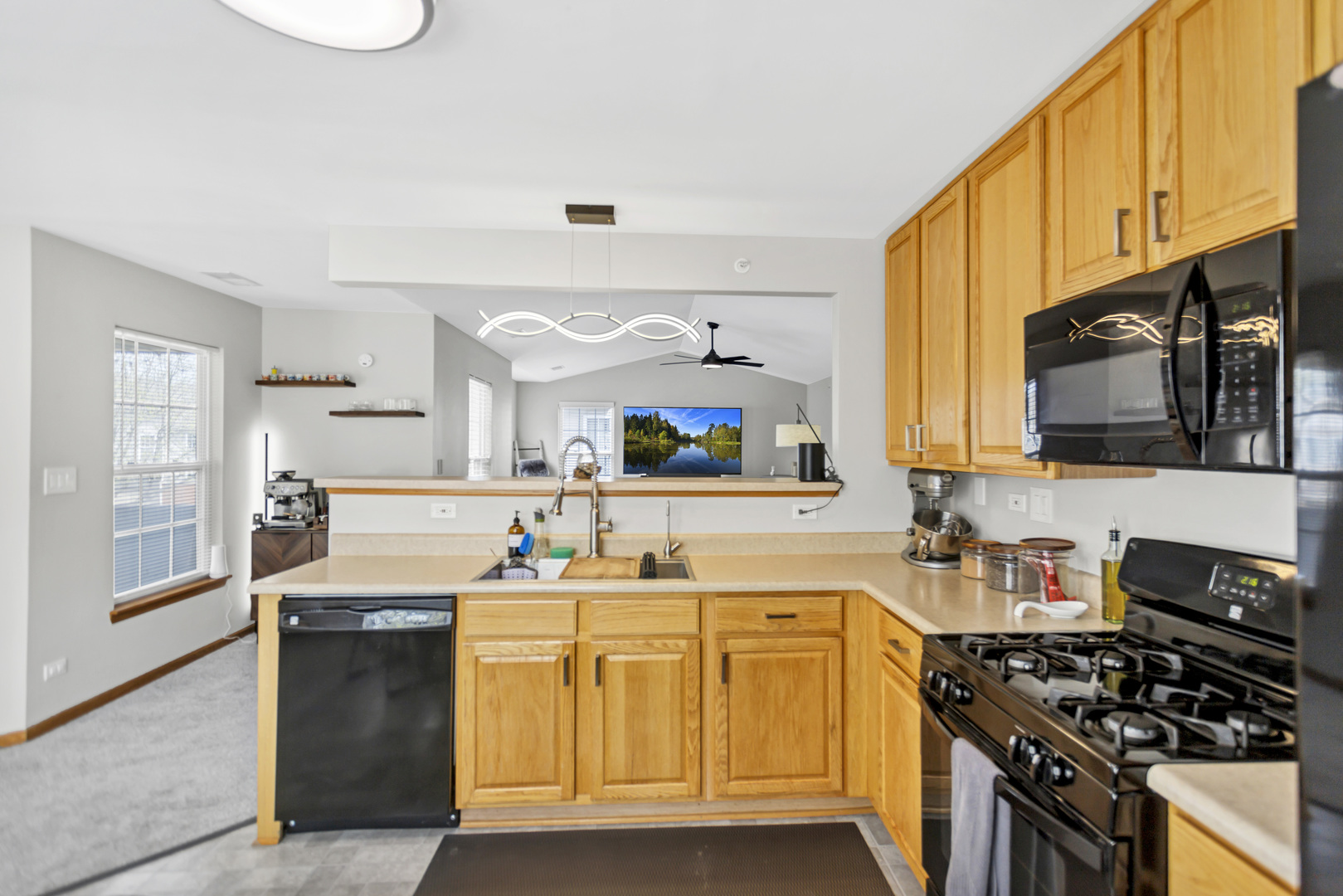 2262 Rockefeller Drive Geneva, IL 60134 - Photo 8 of 25 a kitchen with stainless steel appliances a stove sink microwave and cabinets