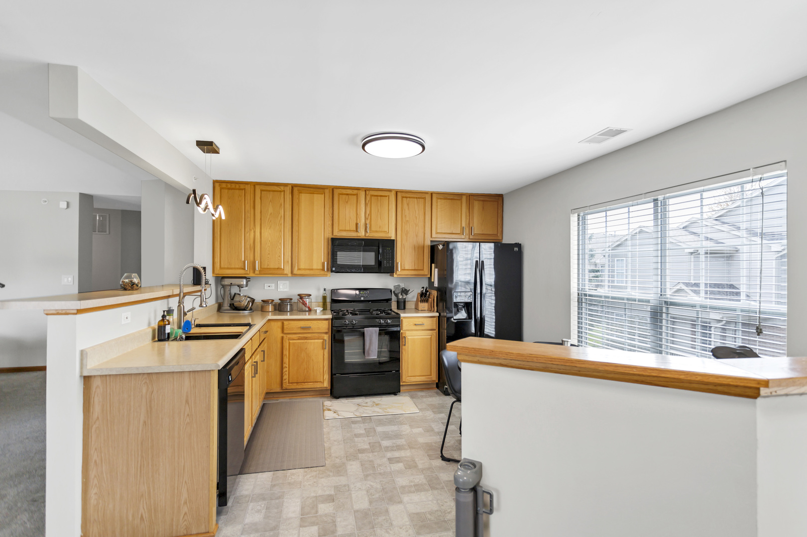 2262 Rockefeller Drive Geneva, IL 60134 - Photo 9 of 25 a kitchen with stainless steel appliances a stove sink refrigerator and a microwave