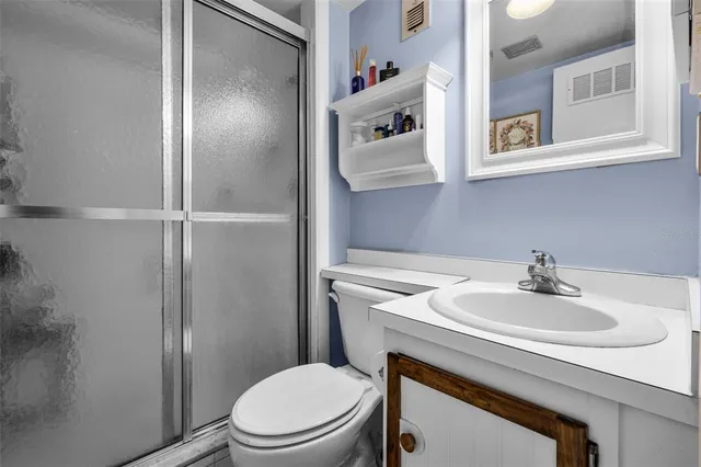 a bathroom with a sink toilet and mirror