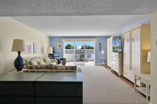 a living room with furniture and large window