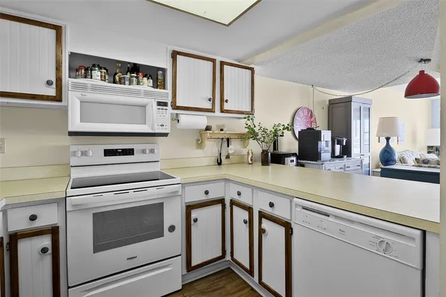 a kitchen with cabinets stainless steel appliances and a sink