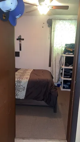 a bedroom with a bed and a window