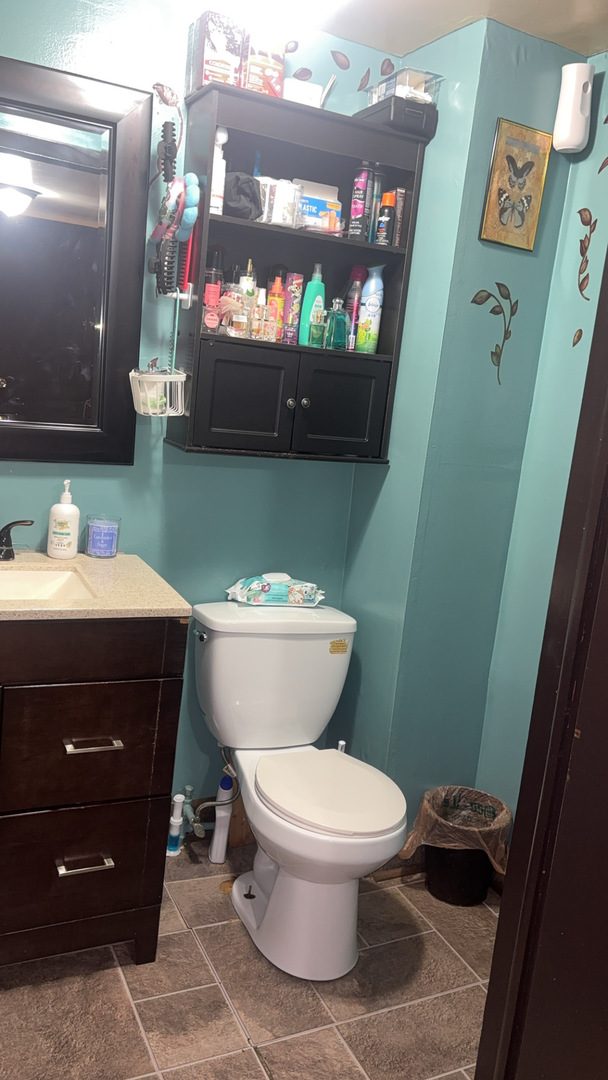 5614 South Kolmar Avenue Chicago, IL 60629 - Photo 14 of 40 a bathroom with a toilet sink and mirror