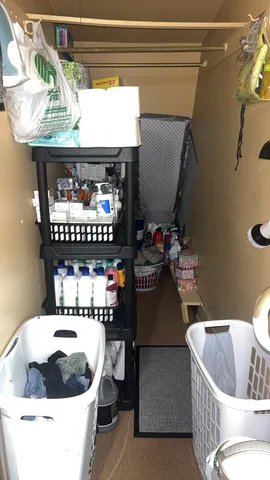 a view of walk in closet with clothes and shoes