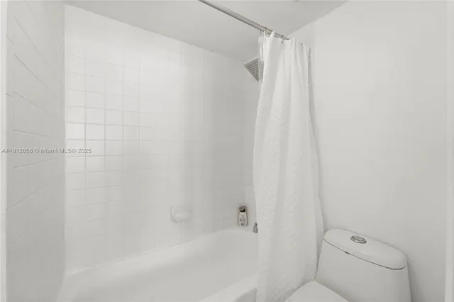 a bathroom with a shower and a toilet