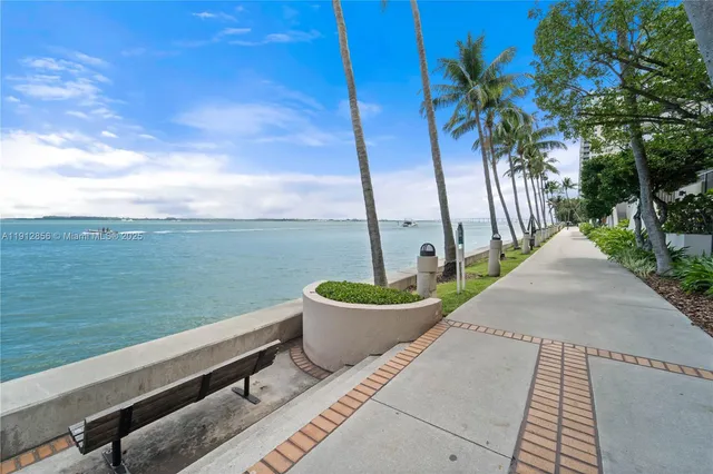 a view of a terrace with lawn chairs