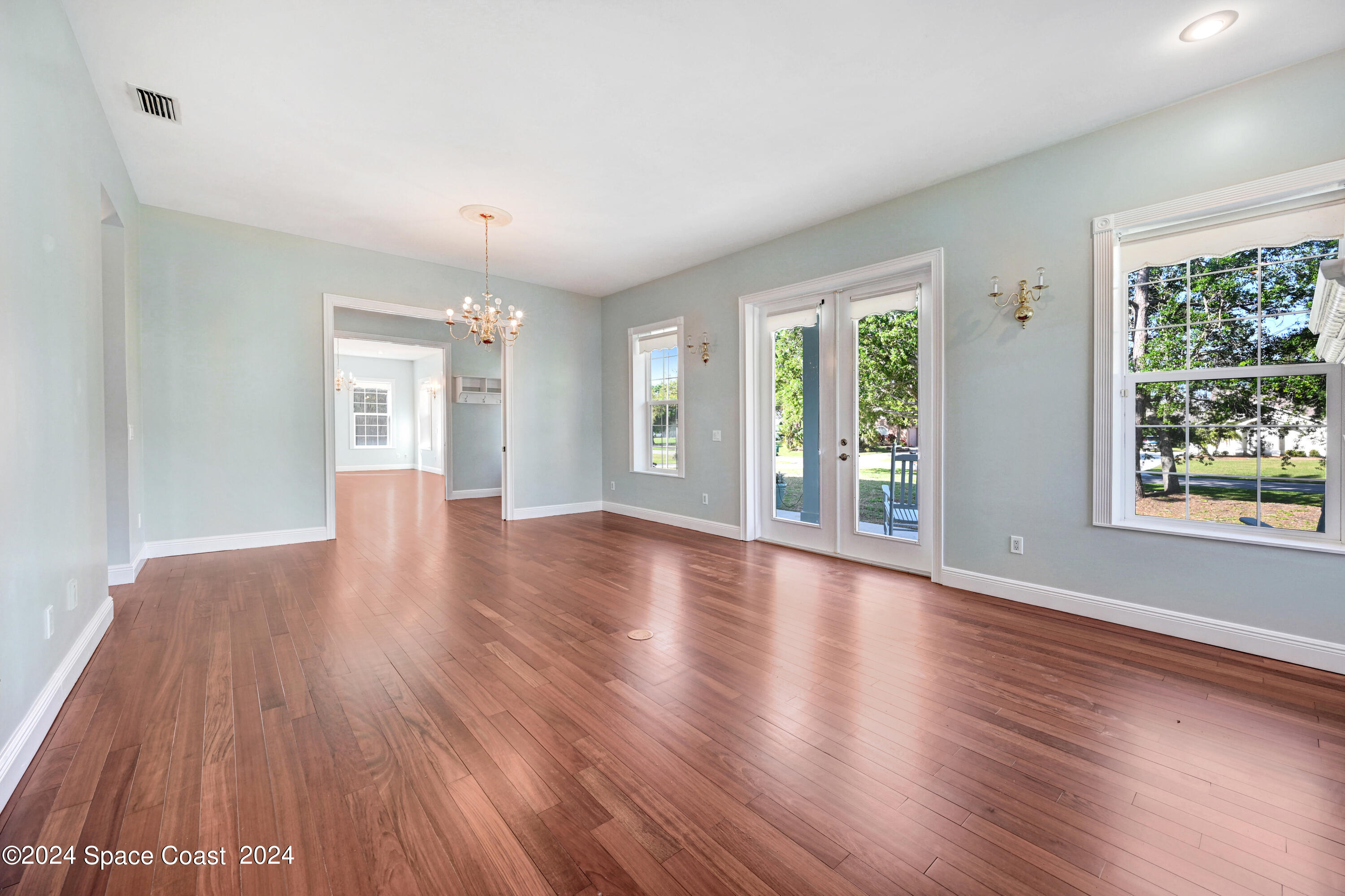4383 Long Lake Road Melbourne, FL 32934 - Photo 20 of 58 a view of an empty room with wooden floor and a window