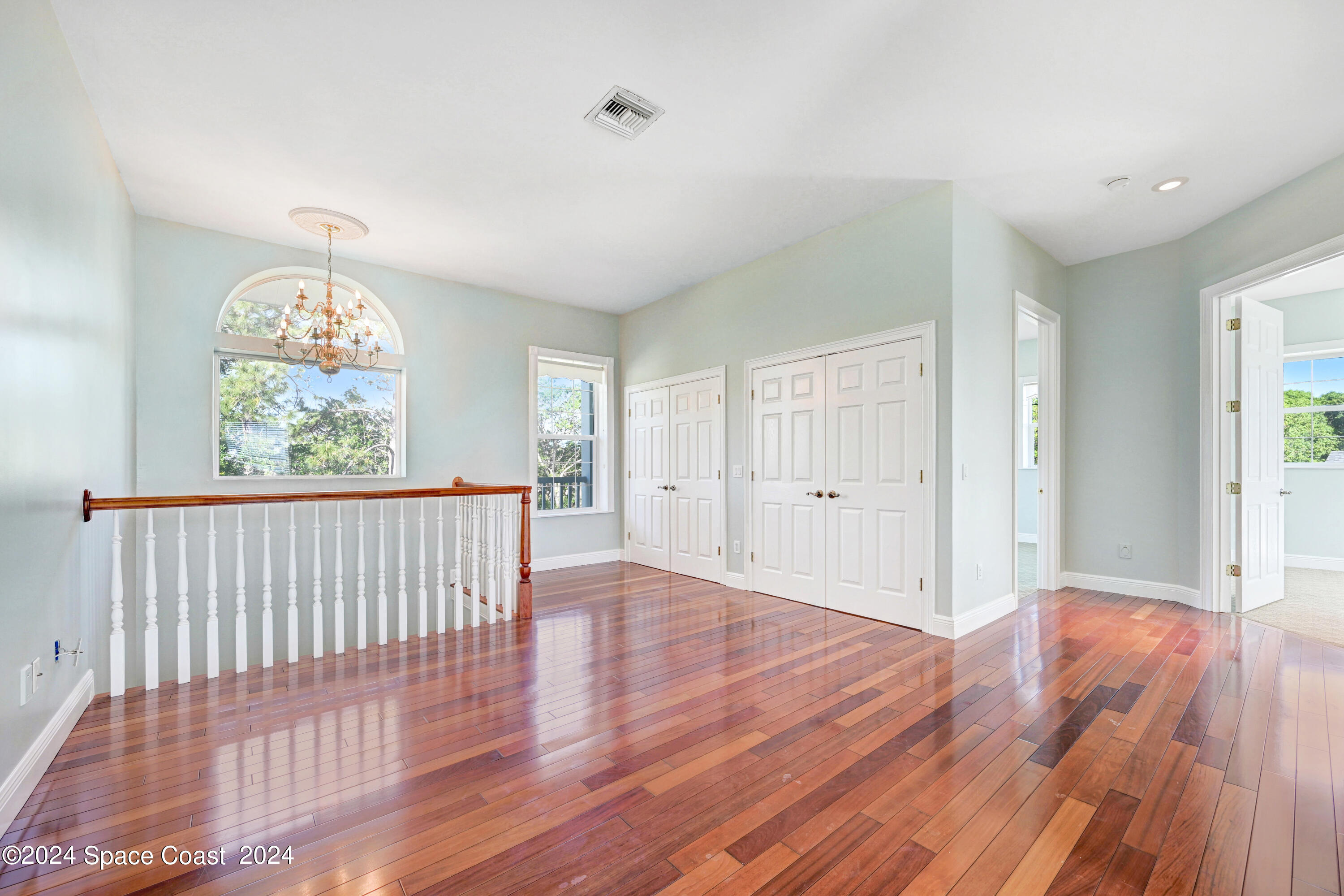 4383 Long Lake Road Melbourne, FL 32934 - Photo 27 of 58 wooden floor in an empty room with a window