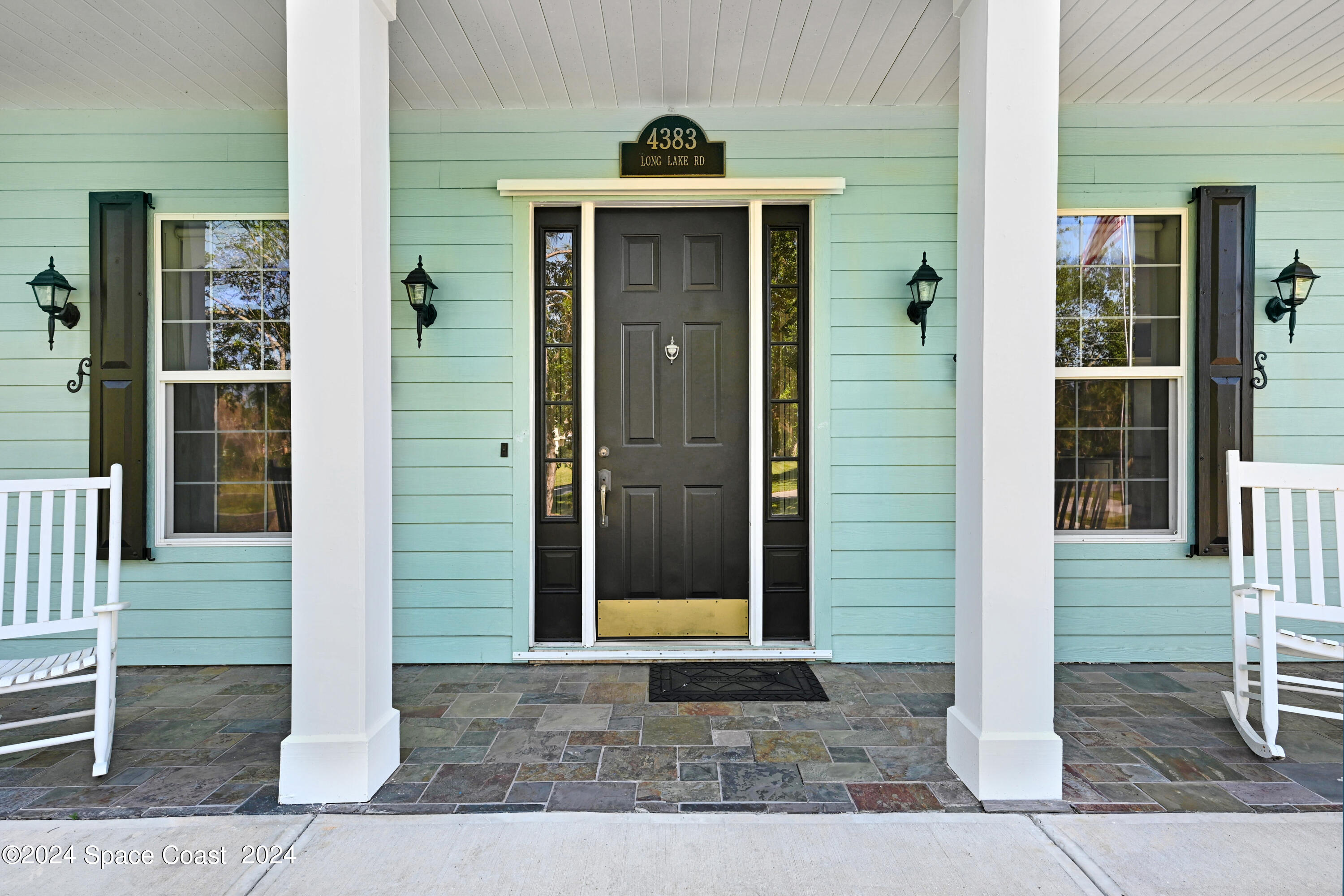 4383 Long Lake Road Melbourne, FL 32934 - Photo 6 of 58 a view of a brick house with glass windows
