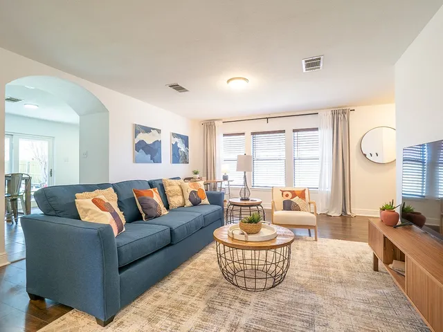 a living room with furniture and a large window