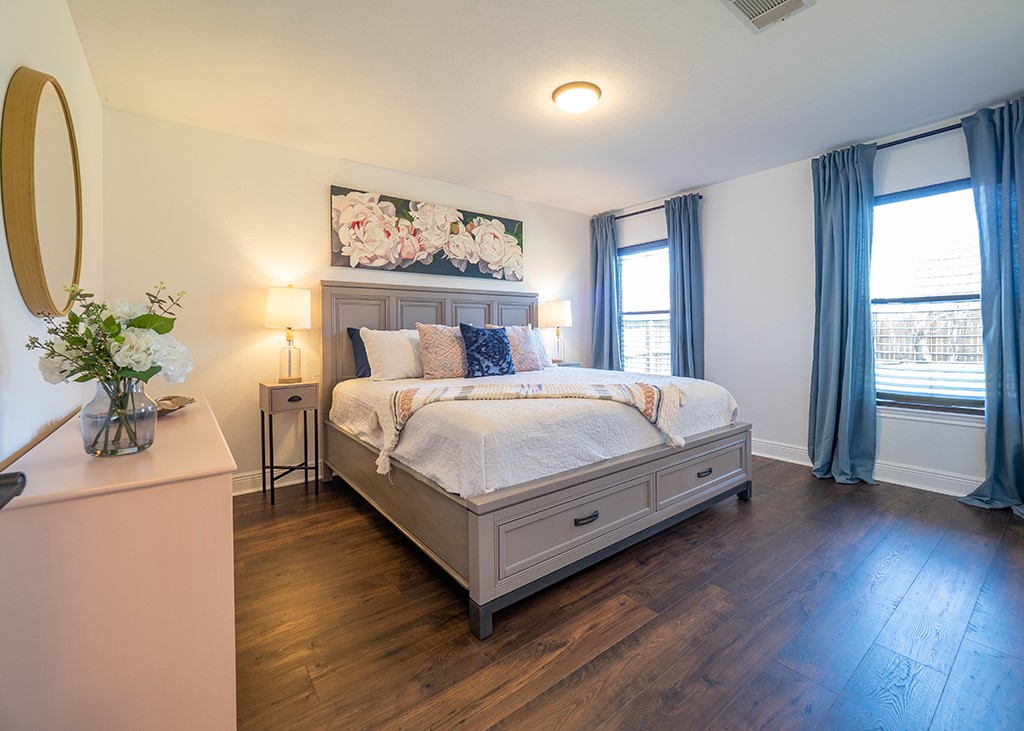 3257 Elizabeth Anne Lane Round Rock, TX 78664 - Photo 13 of 31 a bedroom with a large bed and a chandelier