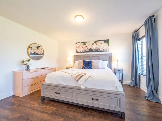 a bedroom with a bed and a window