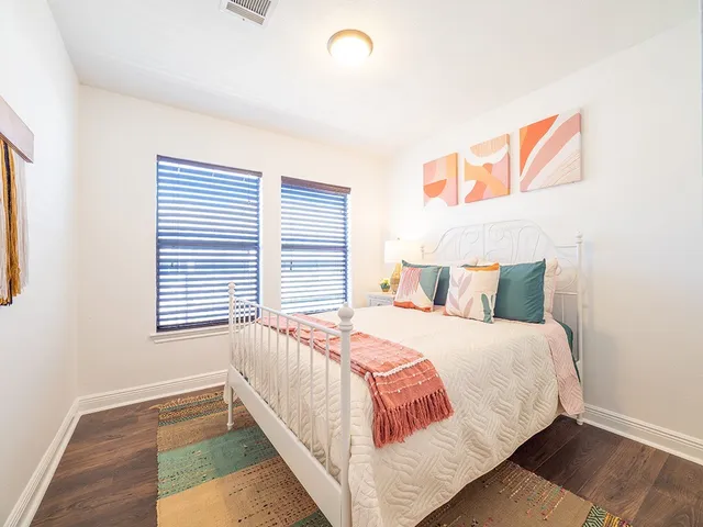 a bedroom with a bed and a window