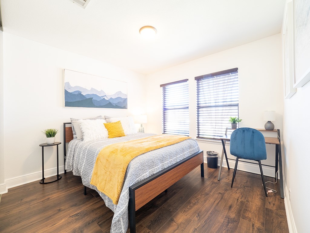 3257 Elizabeth Anne Lane Round Rock, TX 78664 - Photo 19 of 31 a bedroom with a bed a chair and a potted plant with the wooden floor