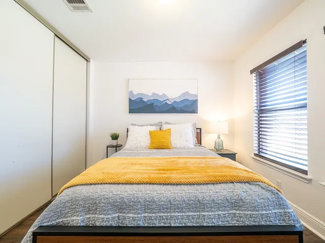 a bedroom with a bed and a window