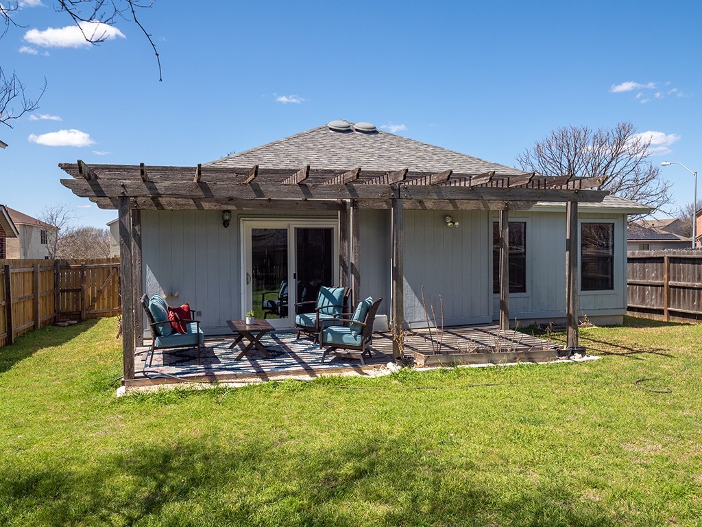 3257 Elizabeth Anne Lane Round Rock, TX 78664 - Photo 25 of 31 a view of a backyard with table and chairs under an umbrella