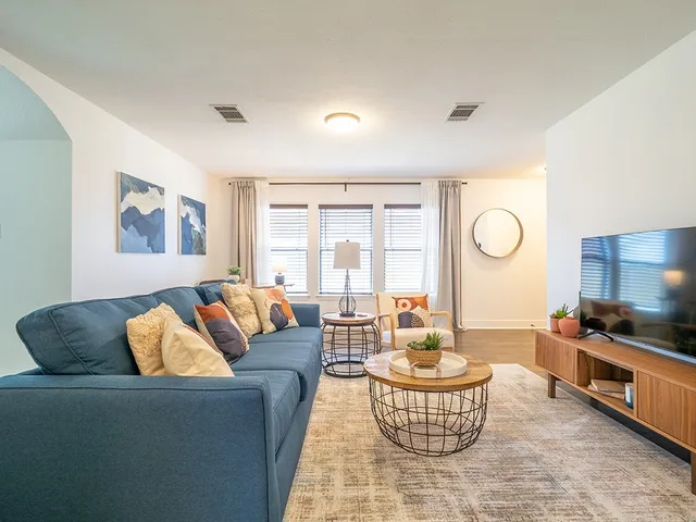 a living room with furniture and a large window