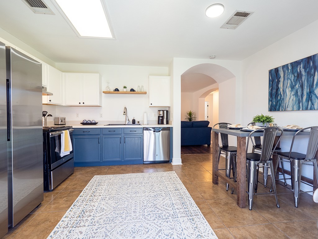 3257 Elizabeth Anne Lane Round Rock, TX 78664 - Photo 9 of 31 a kitchen with stainless steel appliances kitchen island granite countertop a table and chairs in it
