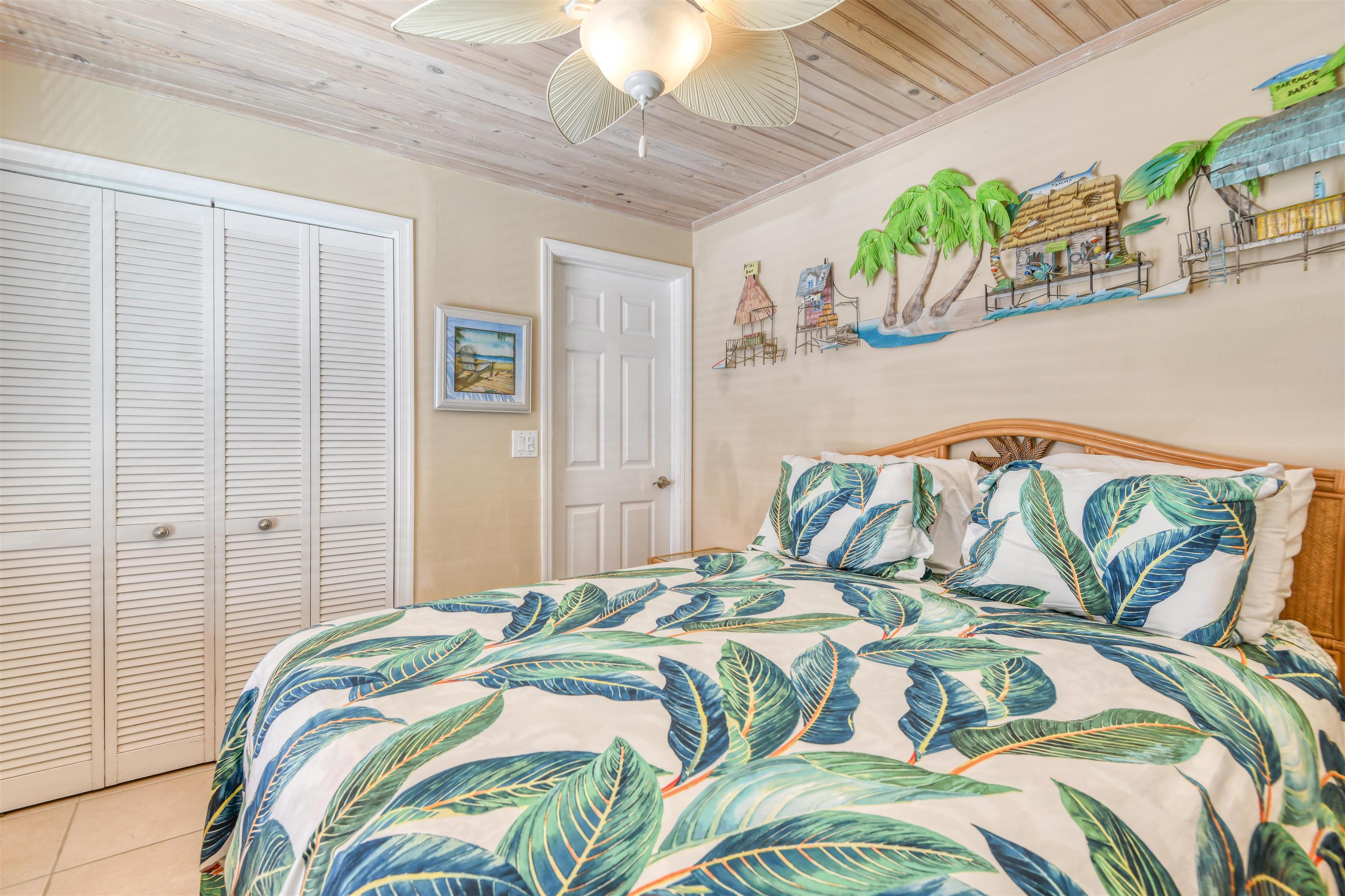 6970 A1A South, Unit 433 St. Augustine, FL 32080 - Photo 19 of 36 a bedroom with a bed and a painting on the wall