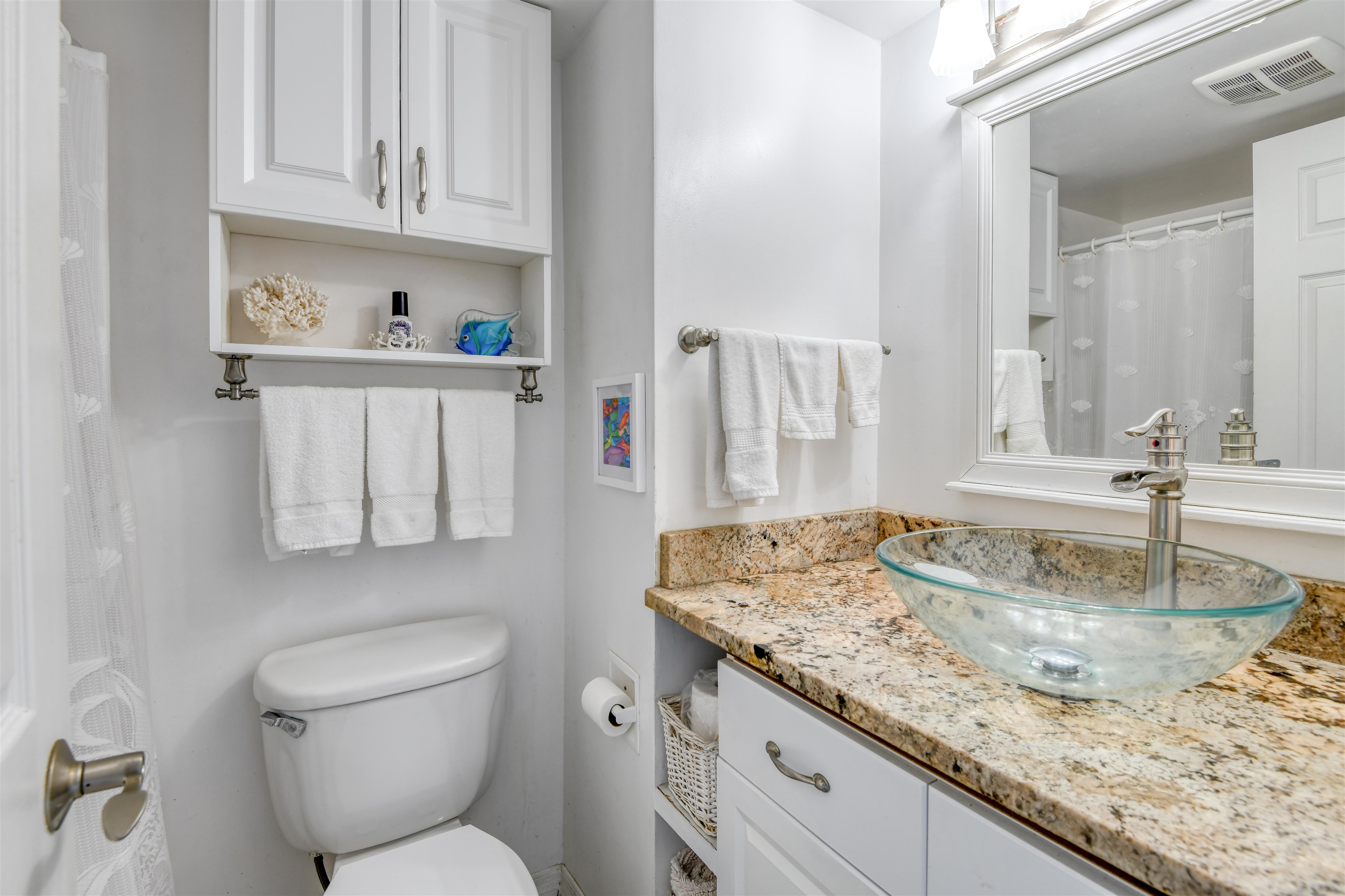 6970 A1A South, Unit 433 St. Augustine, FL 32080 - Photo 20 of 36 a bathroom with a granite countertop sink a toilet and a mirror