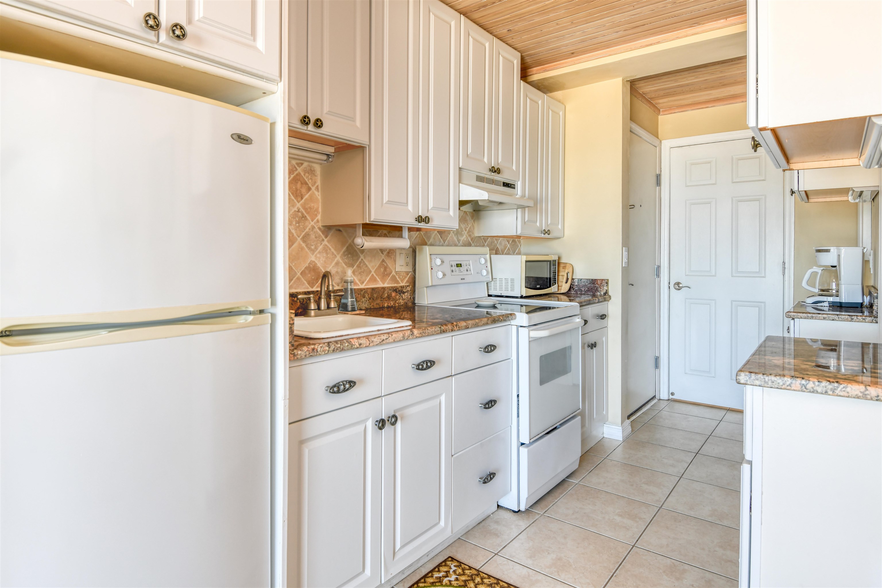 6970 A1A South, Unit 433 St. Augustine, FL 32080 - Photo 4 of 36 a kitchen with stainless steel appliances a refrigerator sink and cabinets