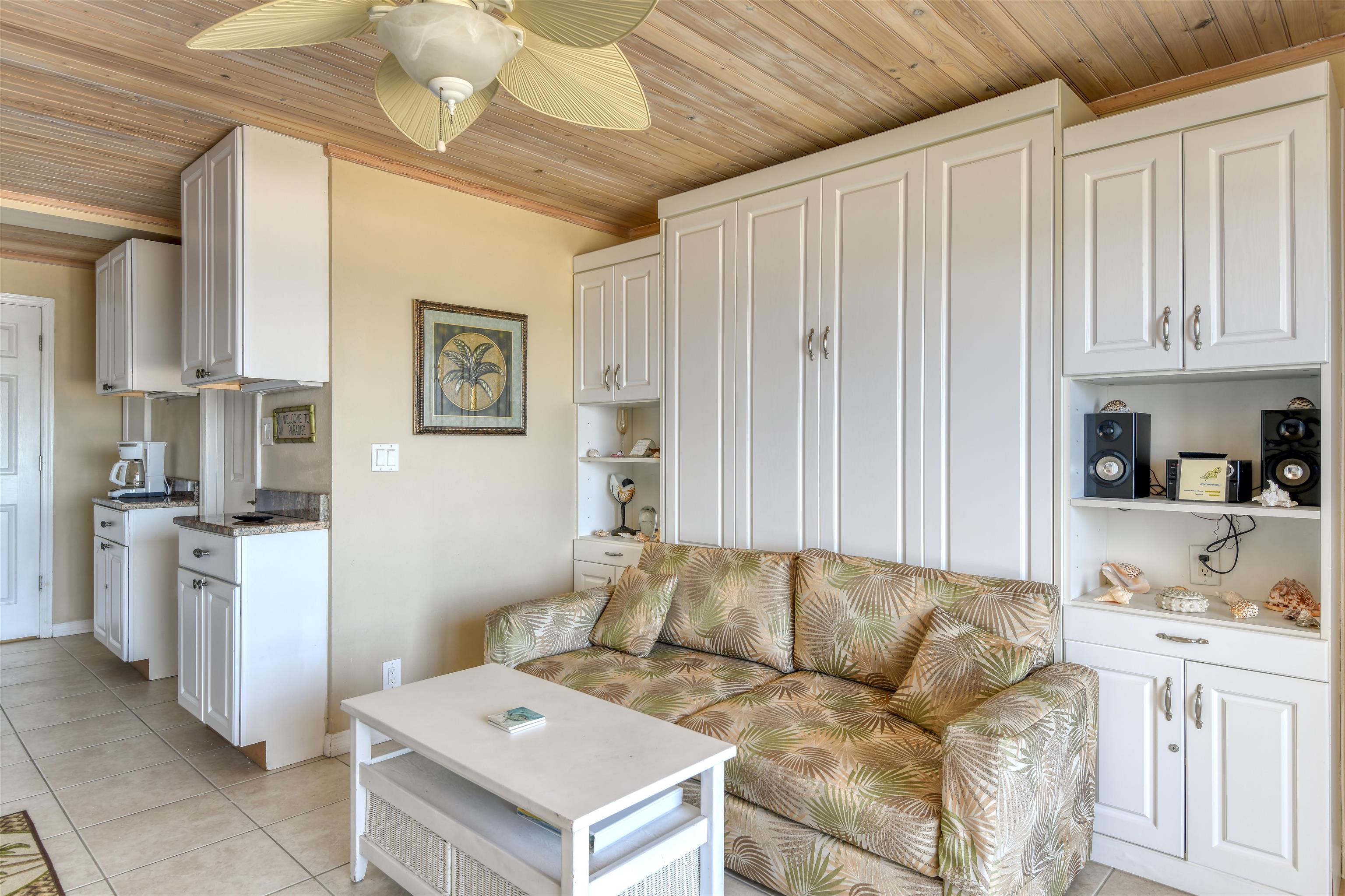 6970 A1A South, Unit 433 St. Augustine, FL 32080 - Photo 7 of 36 a living room with furniture and a kitchen island