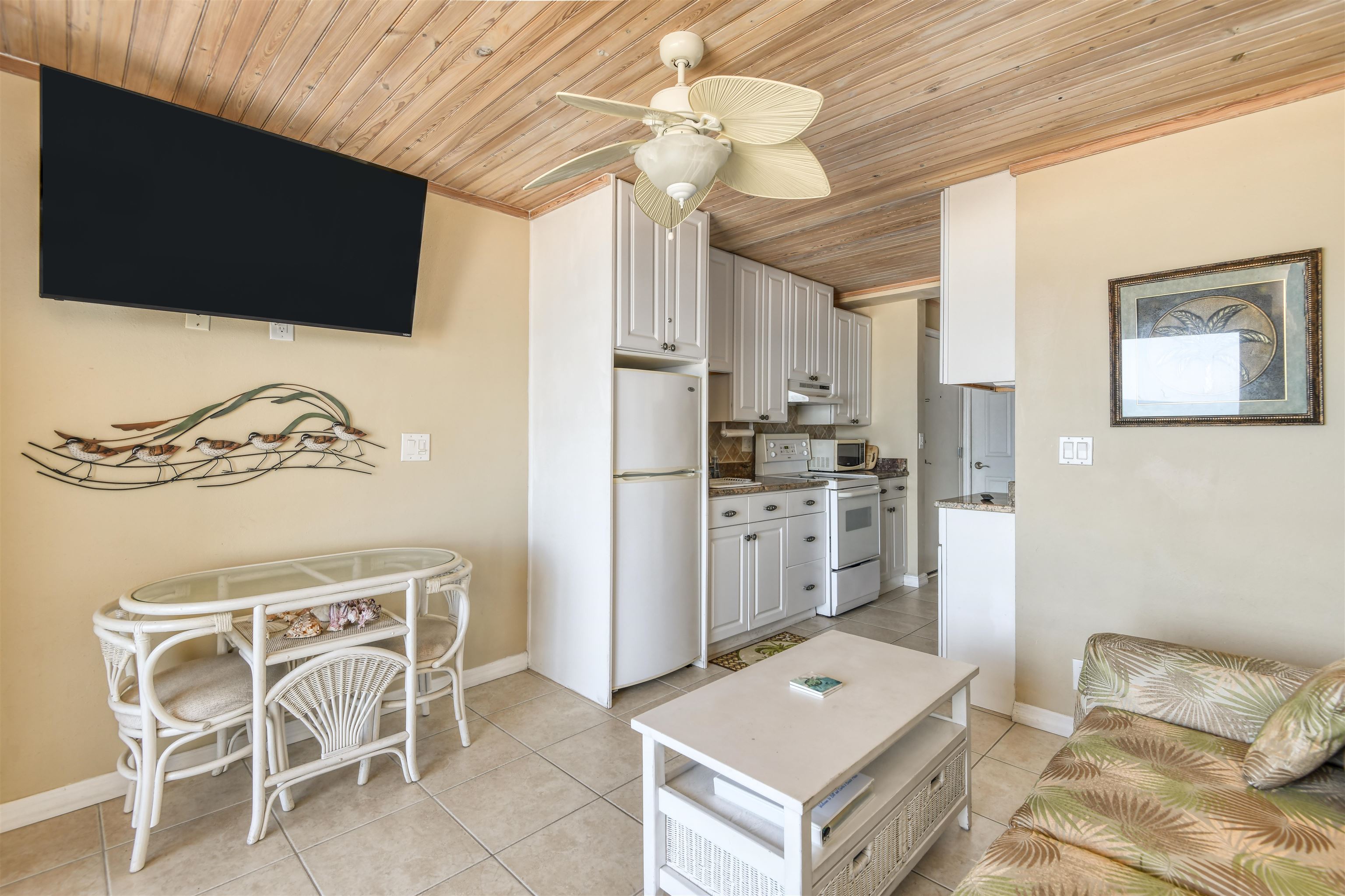 6970 A1A South, Unit 433 St. Augustine, FL 32080 - Photo 8 of 36 a living room with a couch and a chandelier