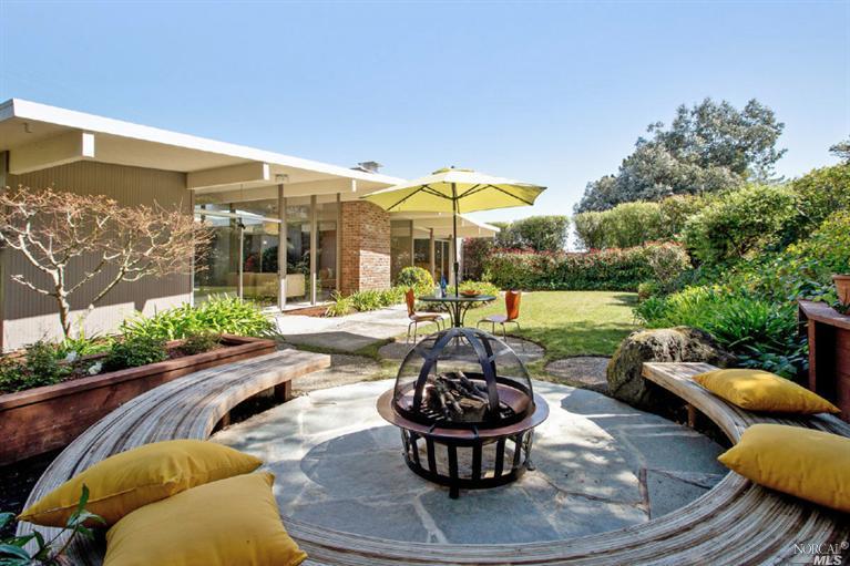 a view of a patio with couches chairs and potted plants