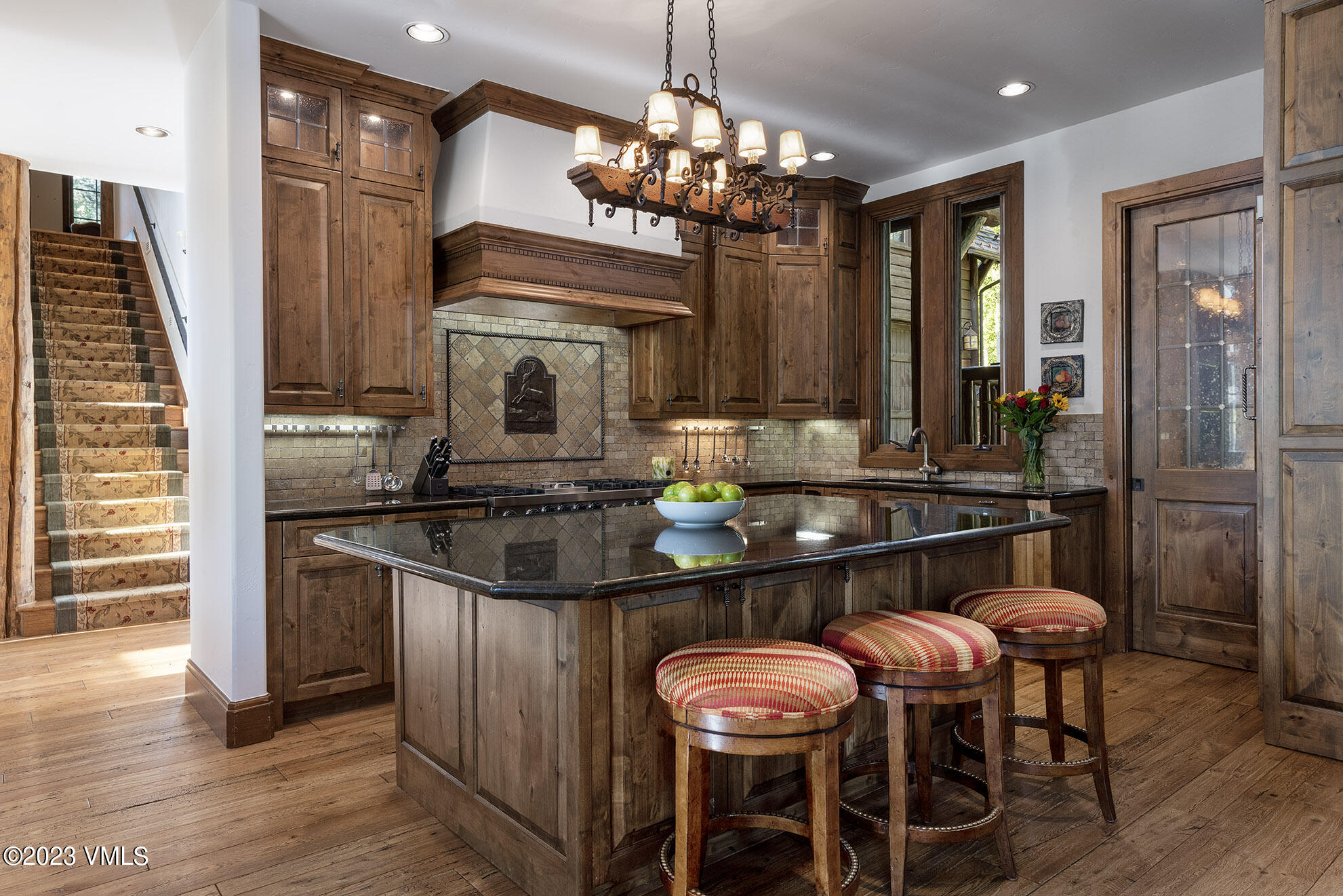2156 Cresta Road Edwards, CO 81632 - Photo 5 of 19 a kitchen with a dining table chairs and chandelier