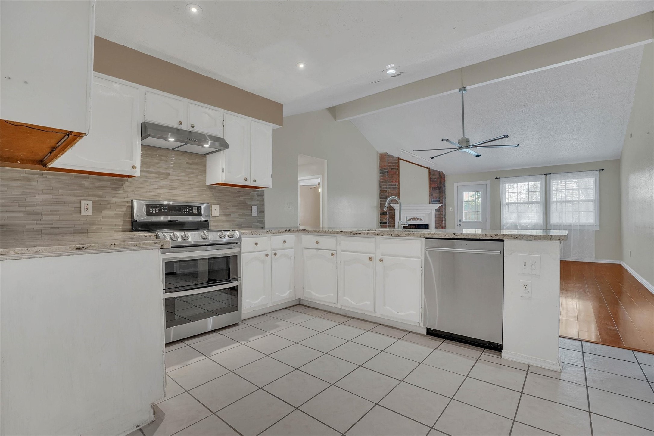 2310 Keyhole Lane Houston, TX 77084 - Photo 11 of 40 a kitchen with white cabinets and white appliances