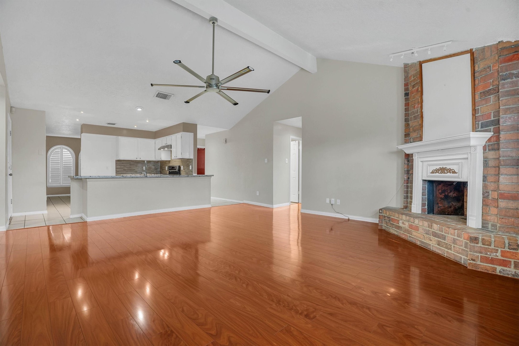 2310 Keyhole Lane Houston, TX 77084 - Photo 12 of 40 a view of a livingroom with a fireplace and wooden floor