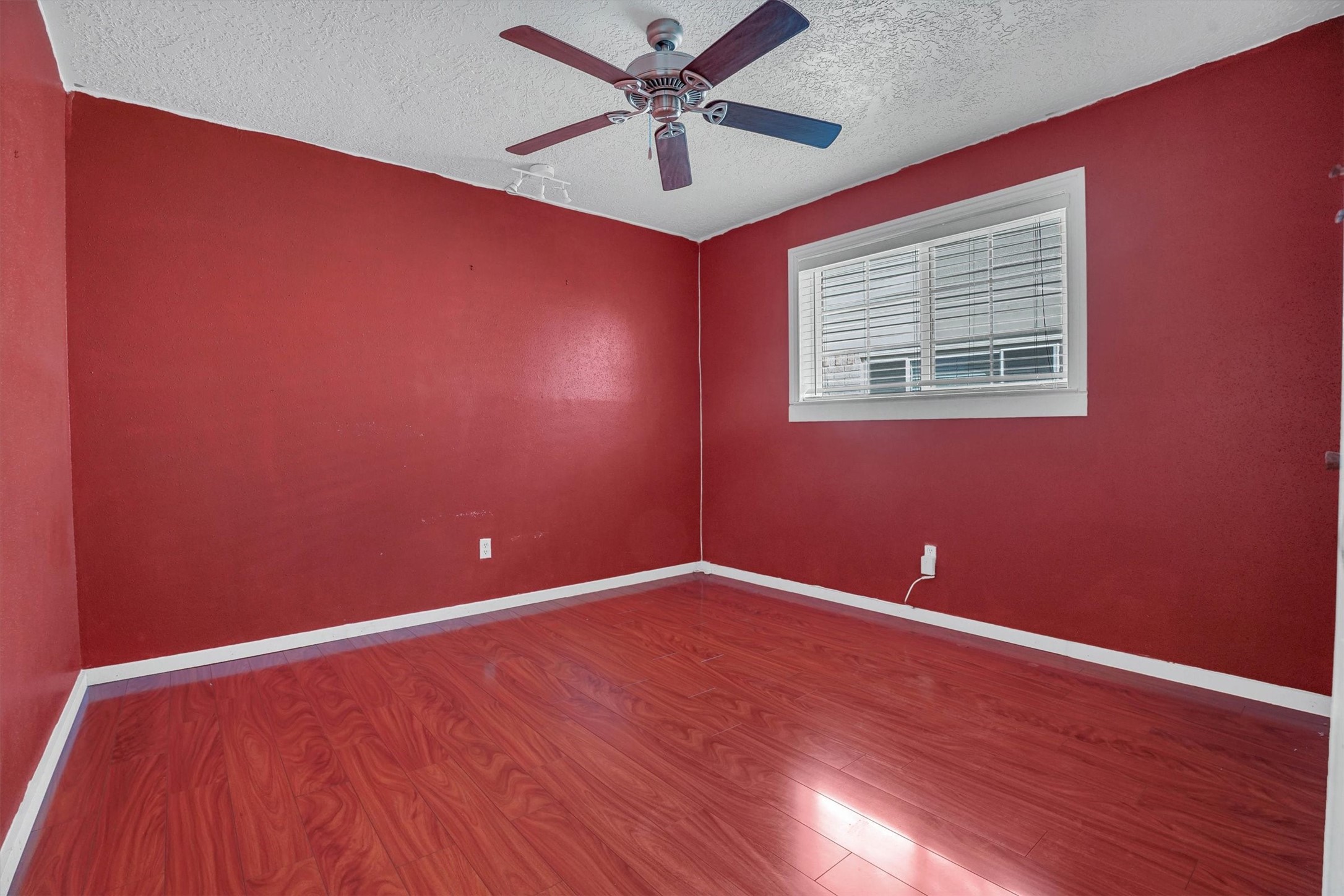 2310 Keyhole Lane Houston, TX 77084 - Photo 17 of 40 a view of an empty room with window and wooden floor