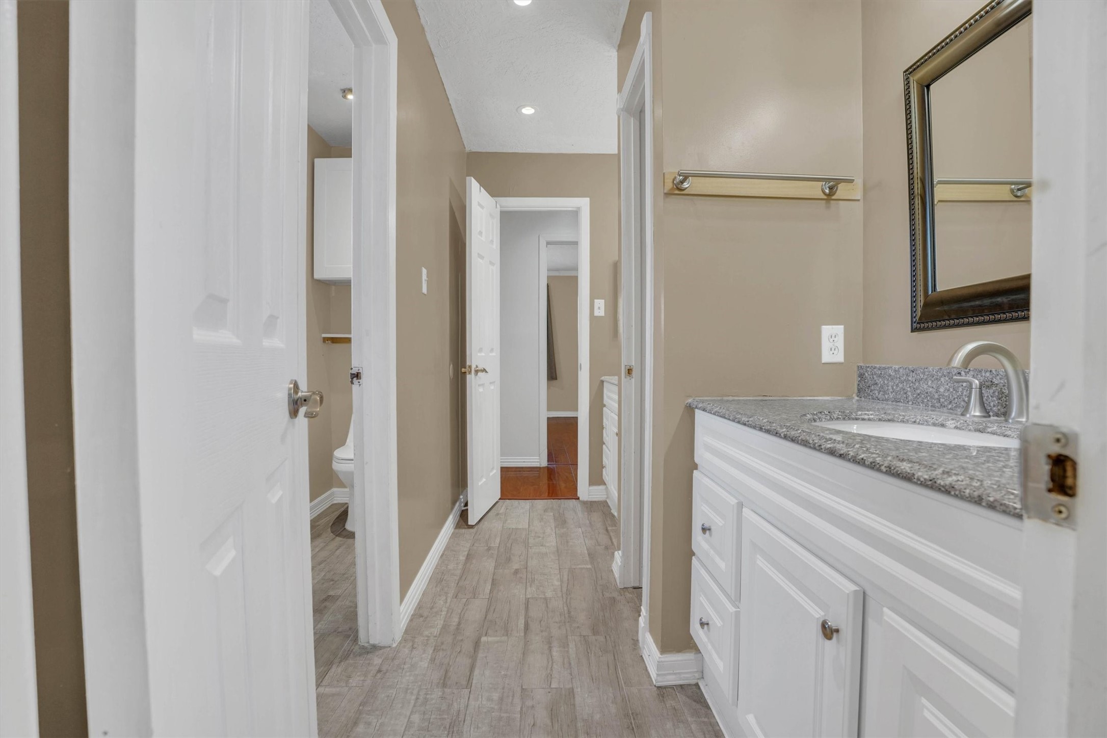 2310 Keyhole Lane Houston, TX 77084 - Photo 21 of 40 a bathroom with a granite countertop sink a mirror and a shower