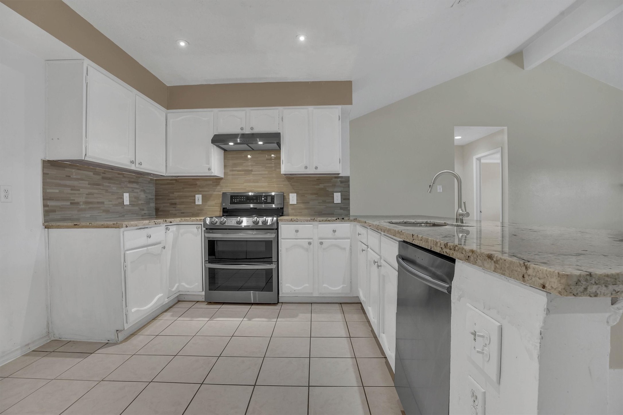 2310 Keyhole Lane Houston, TX 77084 - Photo 9 of 40 a kitchen with a stove sink and cabinets