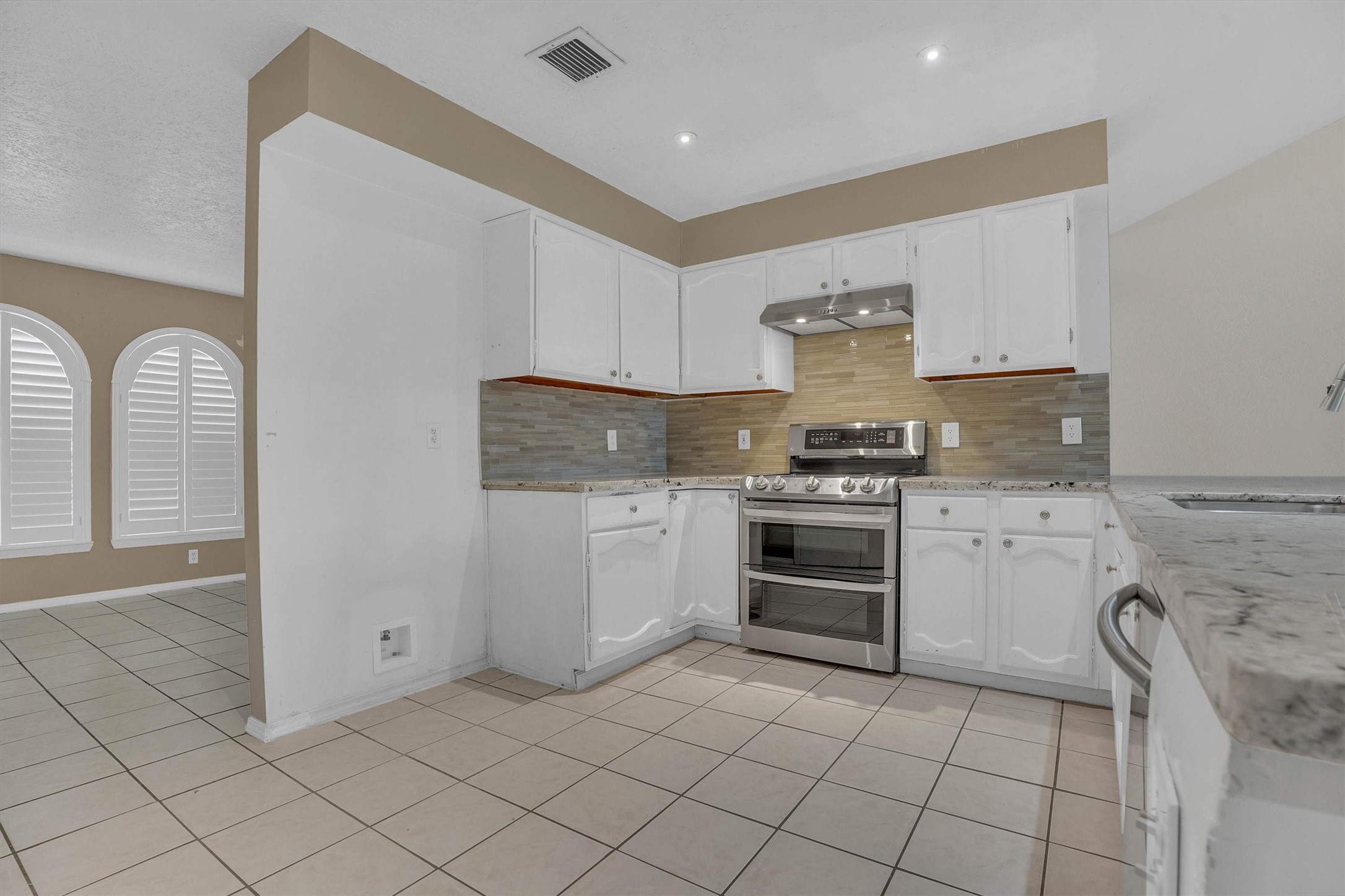 2310 Keyhole Lane Houston, TX 77084 - Photo 10 of 40 a kitchen with a stove sink and cabinets