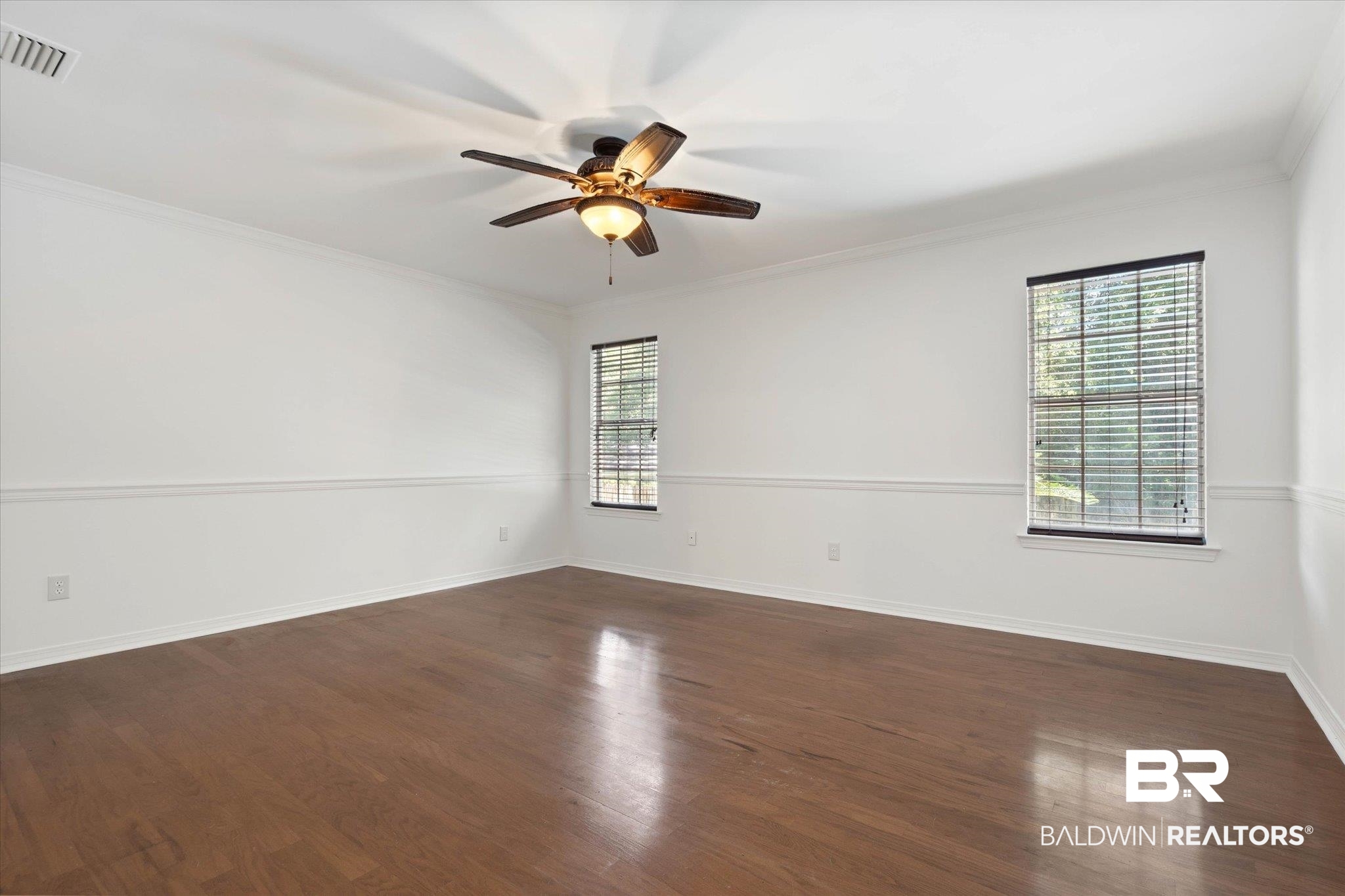 3032 Autumn Ridge Drive West Mobile, AL 36695 - Photo 10 of 20 Spare room featuring ceiling fan, dark wood-style floors, and ornamental molding