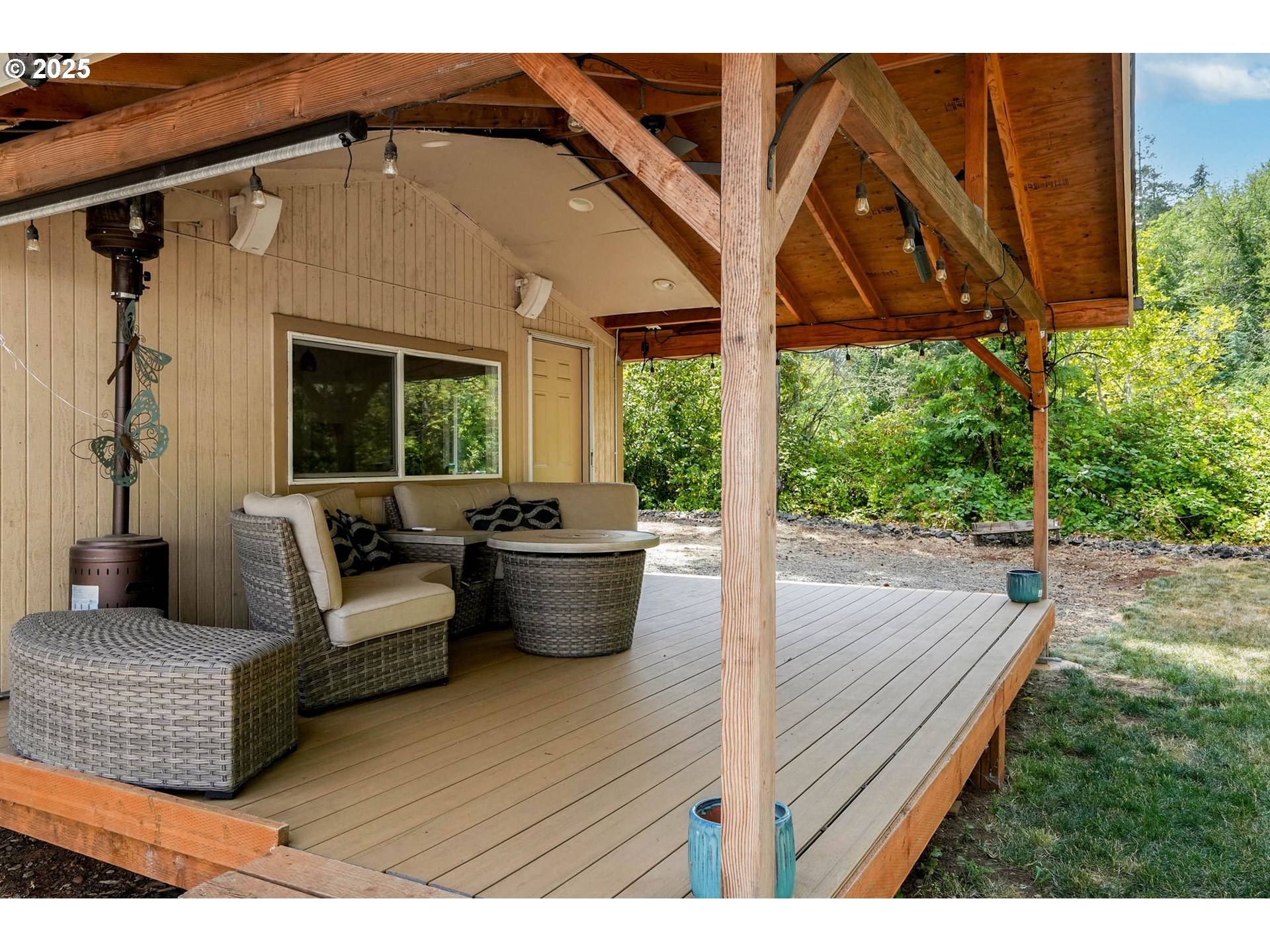 241 Rees Hill Road Southeast Salem, OR 97306 - Photo 33 of 40 a view of a patio with couches chairs potted plants and wooden floor
