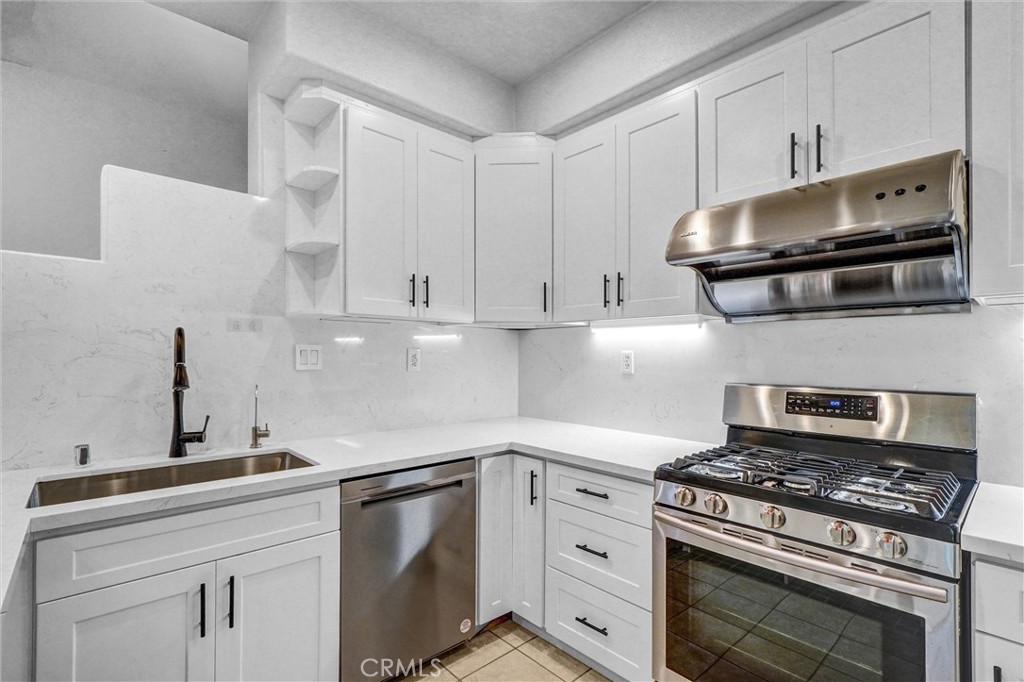 19581 Dorado Drive Lake Forest, CA 92679 - Photo 11 of 32 a kitchen with stainless steel appliances a stove a microwave and cabinets