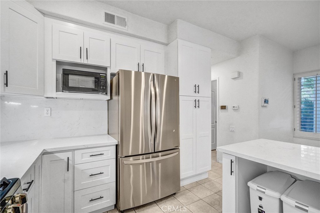 19581 Dorado Drive Lake Forest, CA 92679 - Photo 12 of 32 a kitchen with stainless steel appliances a refrigerator stove and microwave