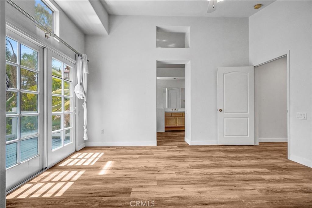 19581 Dorado Drive Lake Forest, CA 92679 - Photo 19 of 32 a view of an empty room with wooden floor and windows