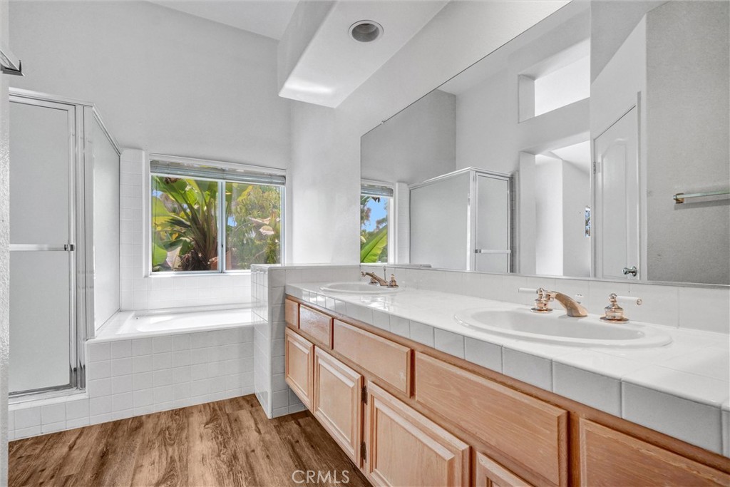 19581 Dorado Drive Lake Forest, CA 92679 - Photo 21 of 32 a bathroom with a granite countertop sink mirror and a bathtub