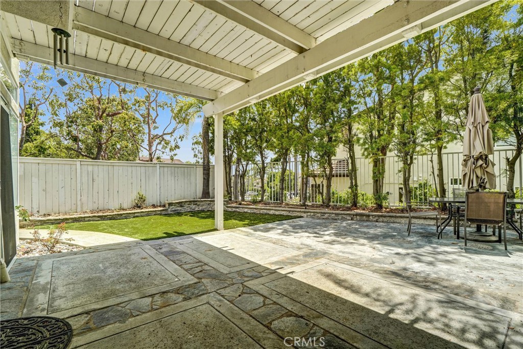 19581 Dorado Drive Lake Forest, CA 92679 - Photo 29 of 32 a view of a backyard with table and chairs and wooden fence