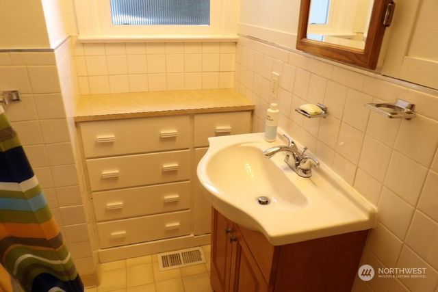 a bathroom with a sink and mirror