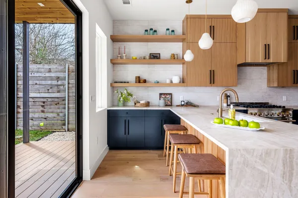 a kitchen with a sink a stove and cabinets