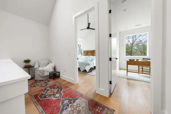 a bedroom with furniture and a wooden floor